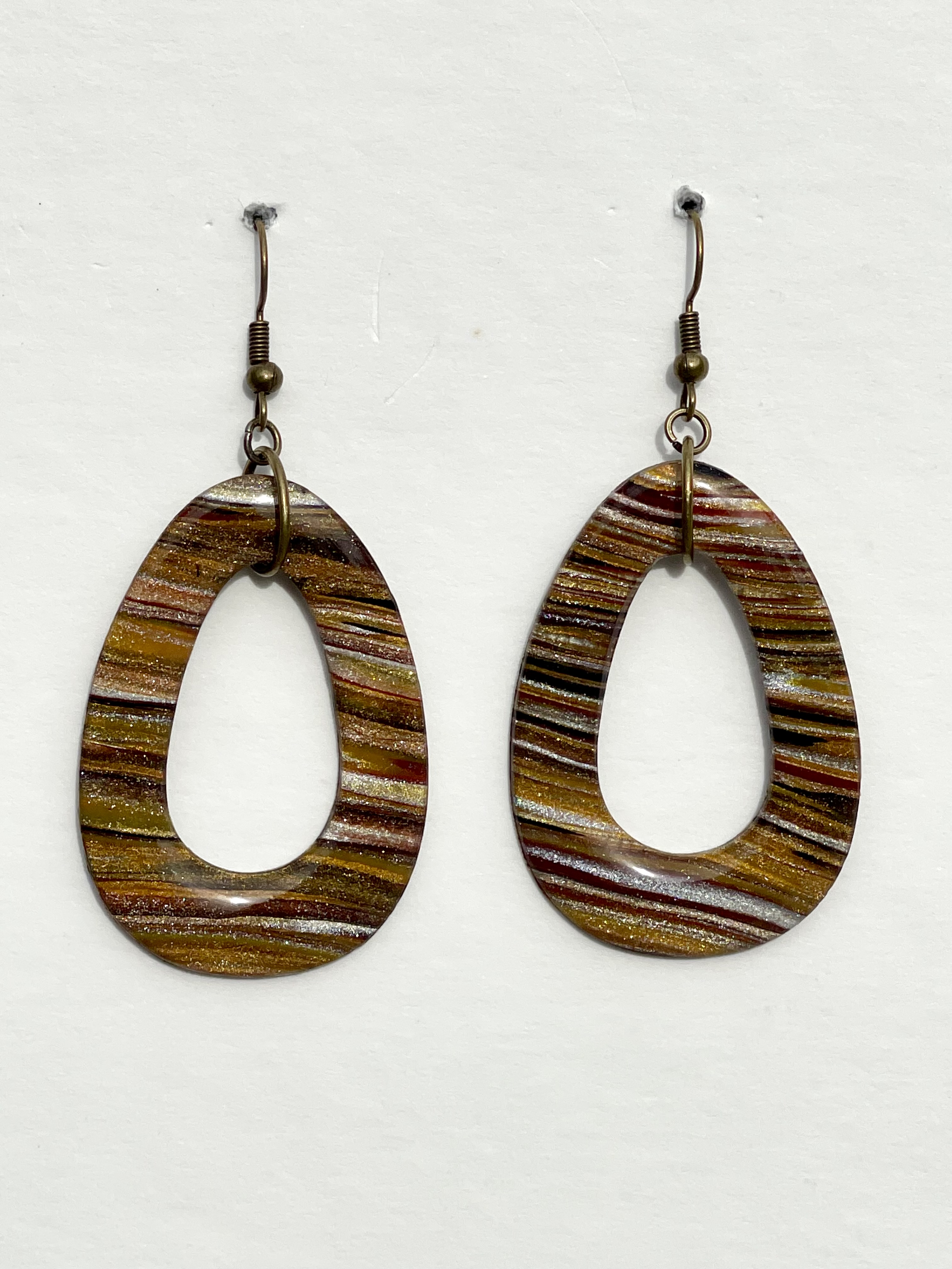 Golden shimmering Earth tone oval hoop